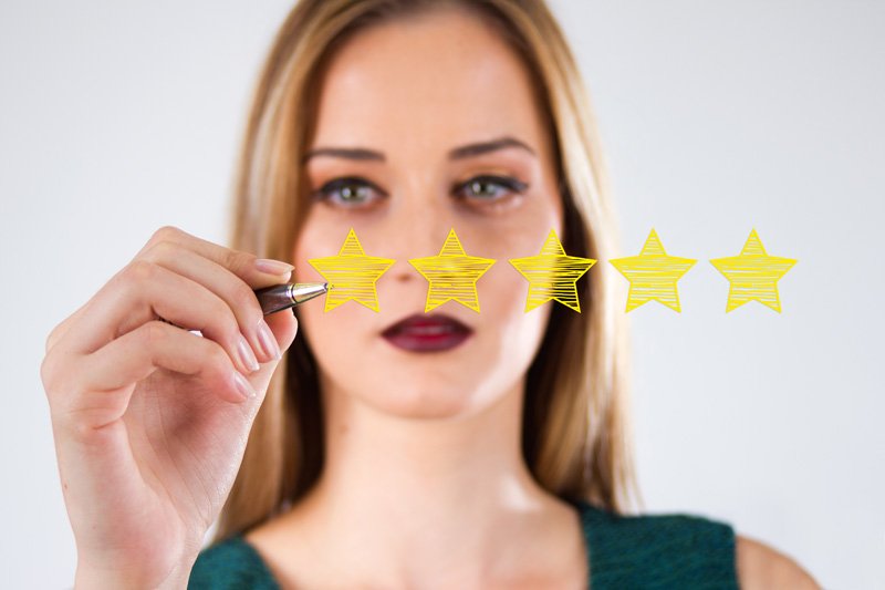 Review, increase rating or ranking, evaluation and classification concept. Businessman draw five yellow star to increase rating of his company.